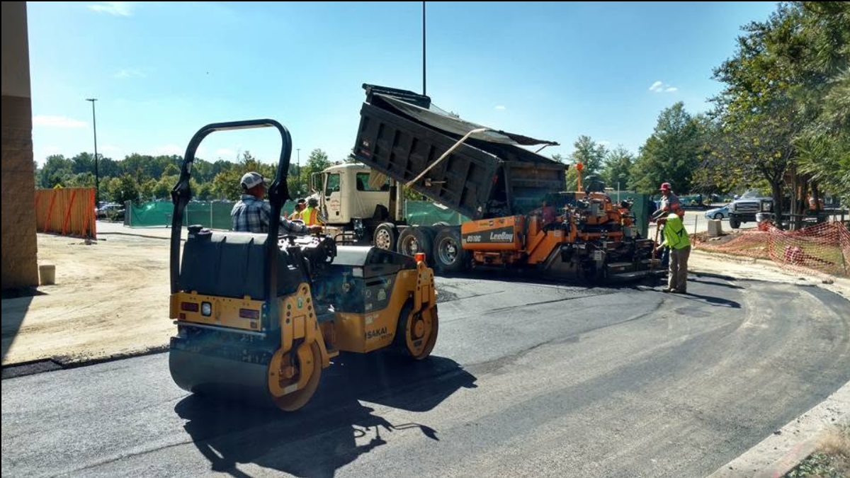United crew laying asphalt with paver and roller